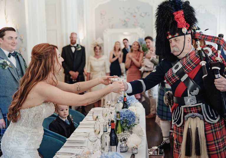Bride shares a quaich with piper at Dean Banks at The Pompadour
